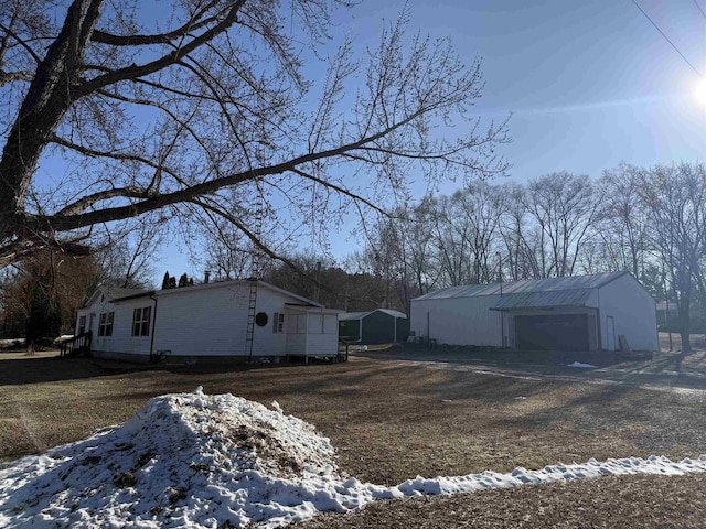 snow covered property featuring an outdoor structure