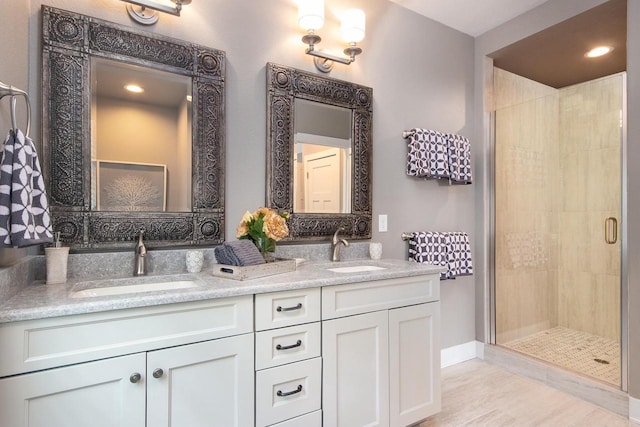 bathroom featuring vanity and a shower with shower door