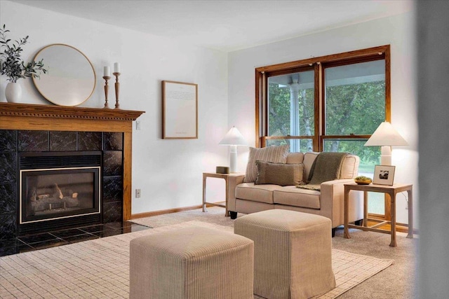 sitting room with a tile fireplace and carpet