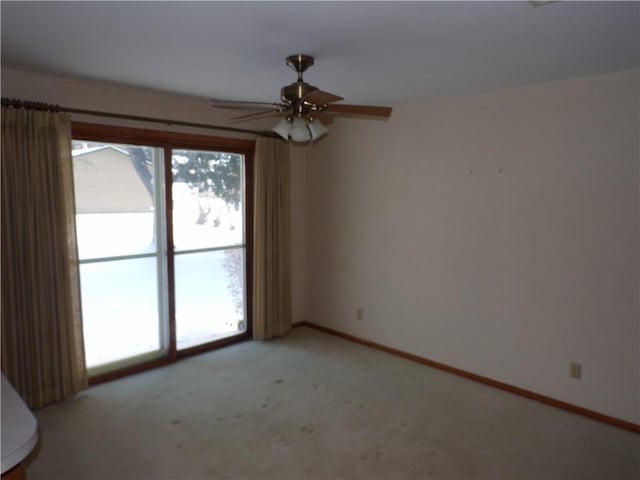 unfurnished room featuring light carpet, plenty of natural light, and ceiling fan