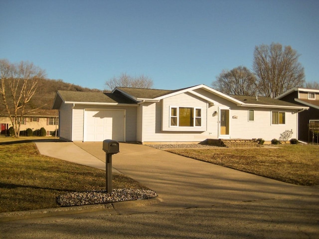 ranch-style home with a front yard and a garage