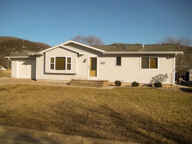 ranch-style home with a garage and a front lawn