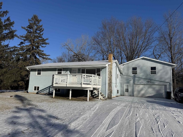 view of front facade with a garage and a wooden deck