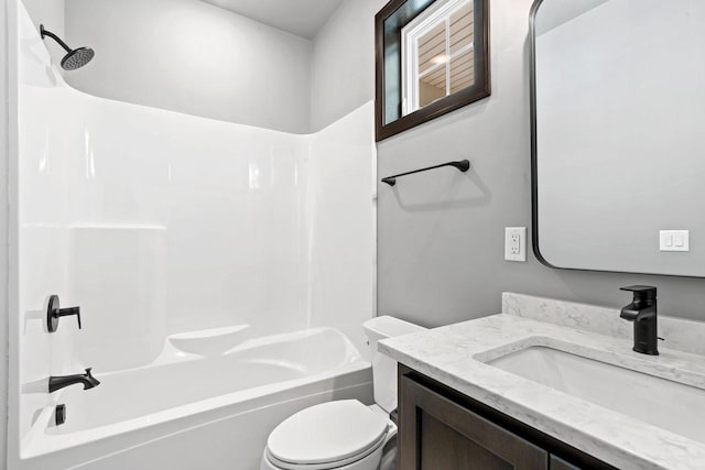 full bathroom featuring vanity, washtub / shower combination, and toilet