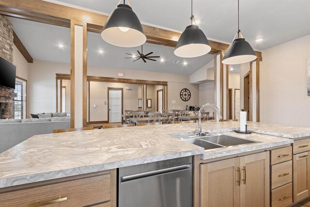 kitchen featuring sink, pendant lighting, lofted ceiling with beams, and light brown cabinets