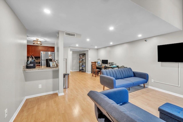 living room with light hardwood / wood-style flooring