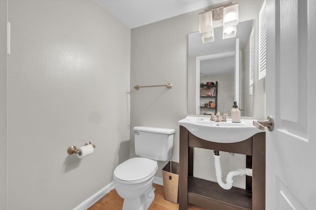 bathroom featuring hardwood / wood-style floors and toilet