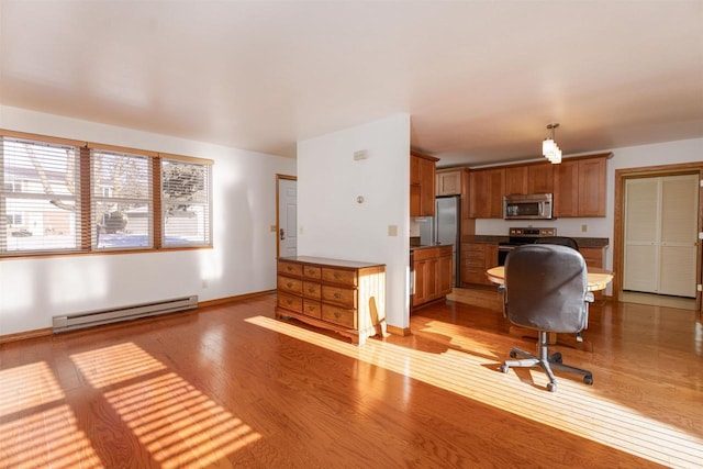 office space featuring baseboard heating and light wood-type flooring