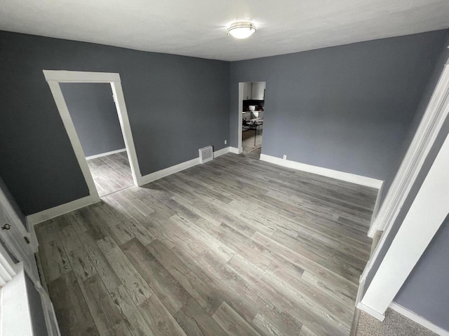 unfurnished room featuring wood-type flooring