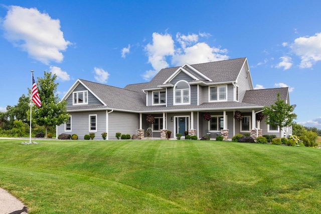 craftsman-style home featuring a porch and a front lawn