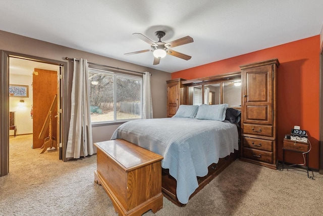 bedroom featuring light colored carpet and ceiling fan