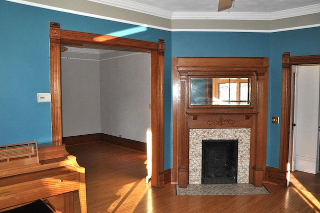 unfurnished living room with a wall unit AC, a tile fireplace, wood-type flooring, and ornamental molding