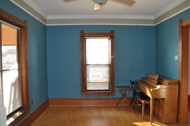 misc room with hardwood / wood-style floors, ceiling fan, and crown molding