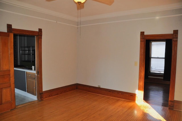 spare room with ceiling fan, wood-type flooring, and ornamental molding