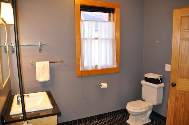 bathroom with tile patterned flooring, vanity, and toilet