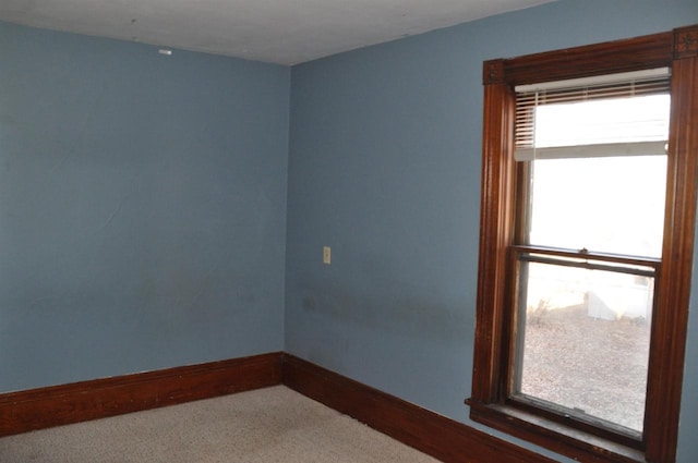 empty room featuring carpet floors and a wealth of natural light