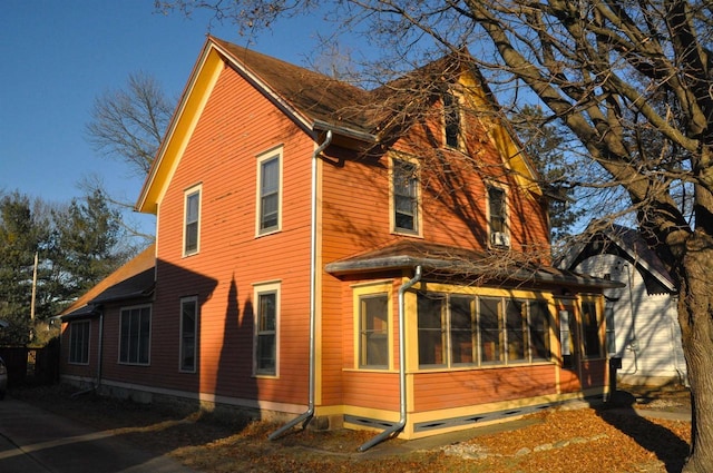 view of side of home with a sunroom