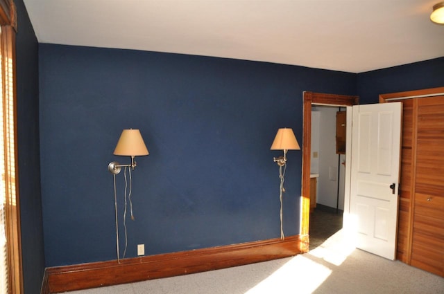 unfurnished bedroom featuring carpet and a closet