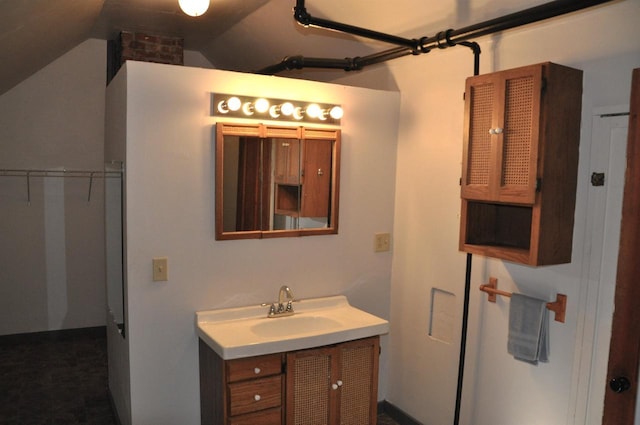 bathroom featuring vanity and vaulted ceiling