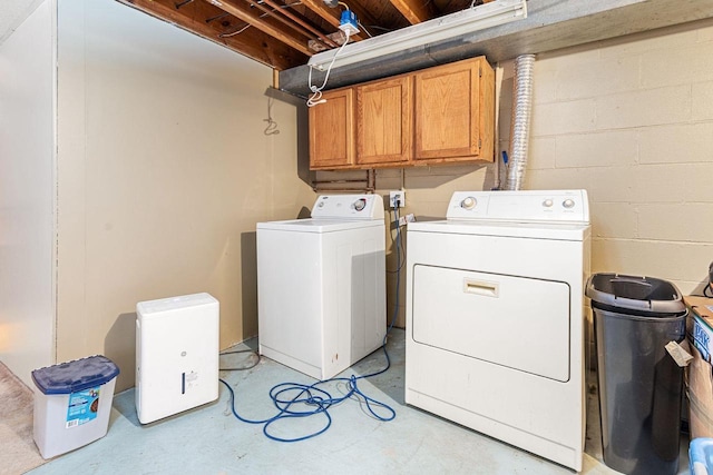 washroom featuring cabinets and independent washer and dryer