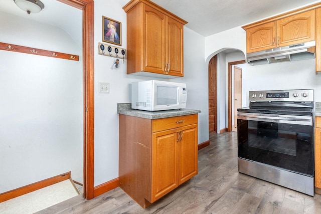 kitchen featuring dark wood-type flooring and stainless steel electric range