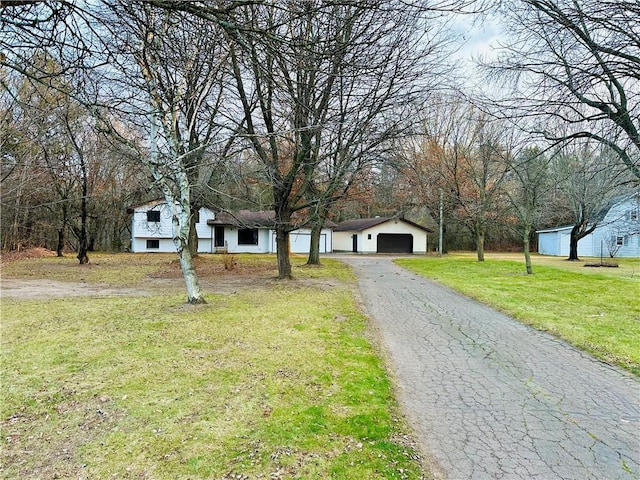 view of front facade with a front yard and a garage