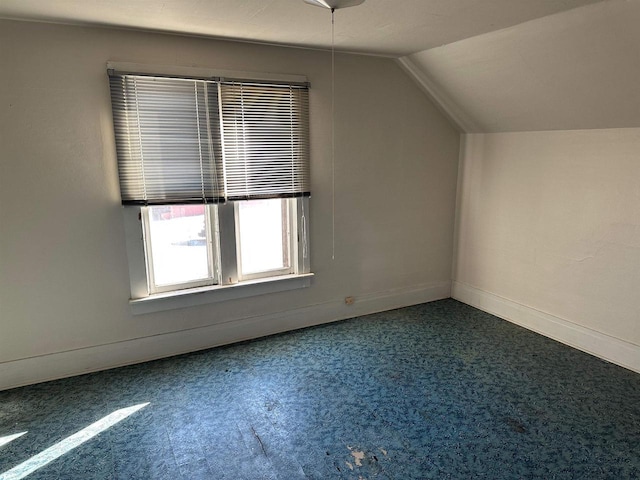 bonus room with lofted ceiling and carpet floors