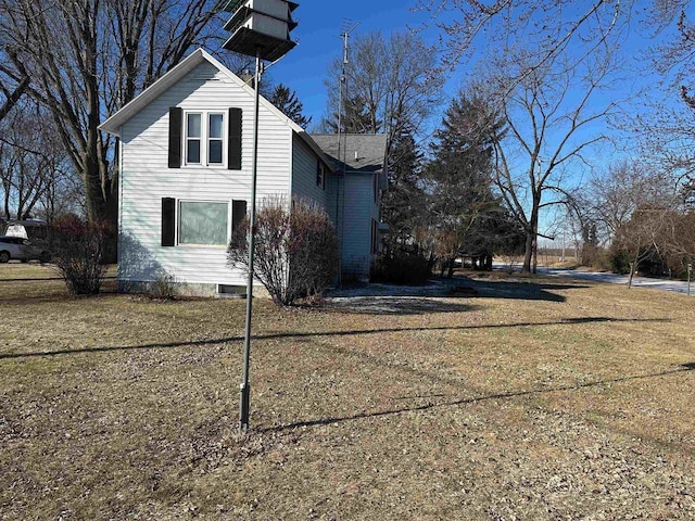 view of side of home featuring a lawn