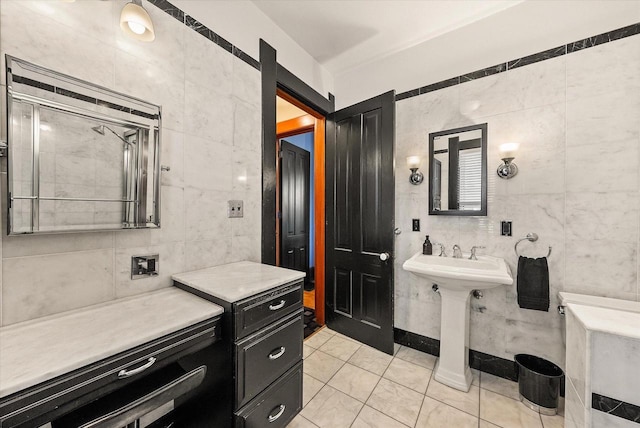 bathroom featuring tile walls, a shower with shower door, and tile patterned floors