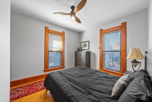 bedroom with ceiling fan and wood-type flooring