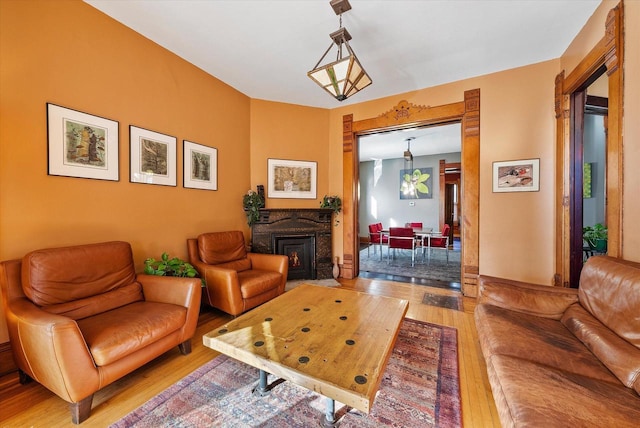 living room featuring wood-type flooring and an inviting chandelier