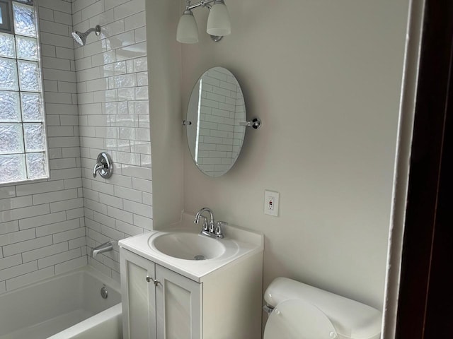 full bathroom with vanity, toilet, and tiled shower / bath combo