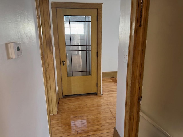 corridor with light hardwood / wood-style floors