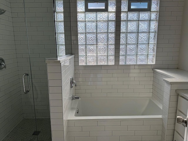 bathroom with separate shower and tub