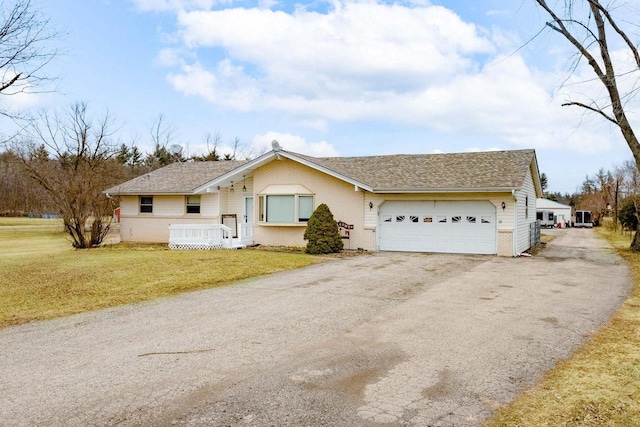 single story home with a front yard and a garage