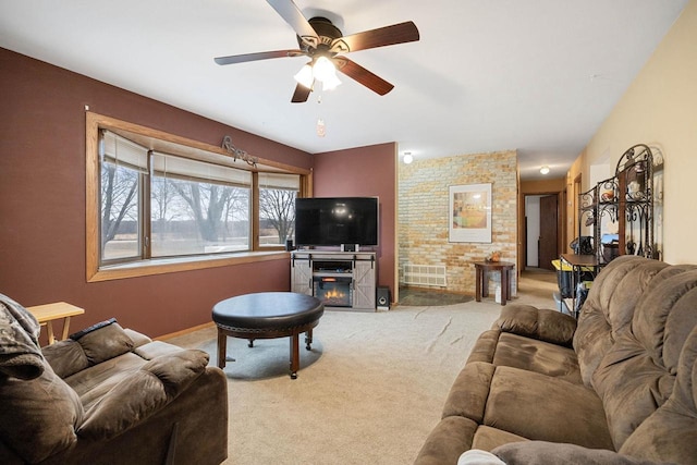 carpeted living room with ceiling fan