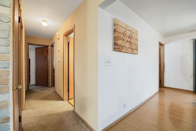 hallway with light colored carpet