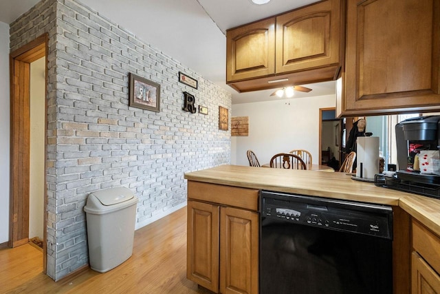 kitchen with wood counters, brick wall, ceiling fan, light hardwood / wood-style flooring, and black dishwasher