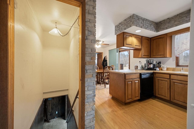 kitchen with pendant lighting, dishwasher, sink, light hardwood / wood-style flooring, and ceiling fan