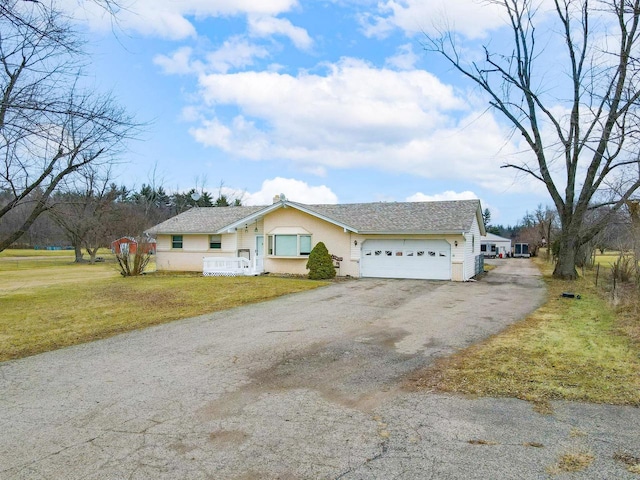 ranch-style home with a front lawn and a garage