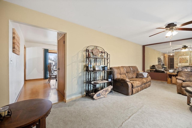 carpeted living room with ceiling fan