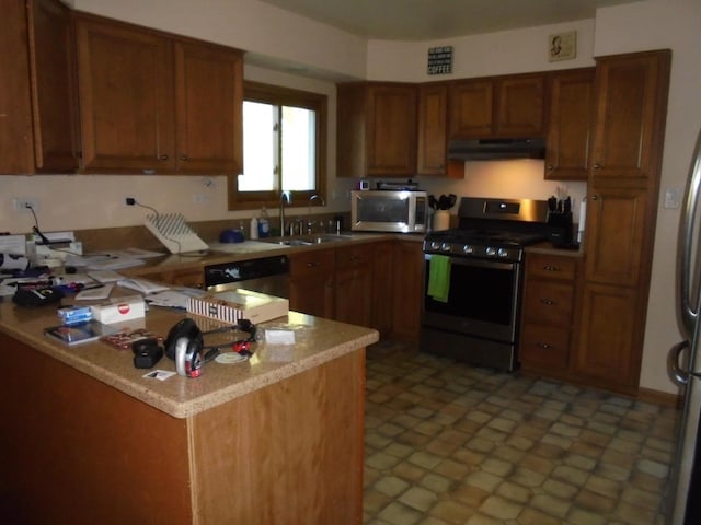 kitchen featuring kitchen peninsula, sink, and appliances with stainless steel finishes