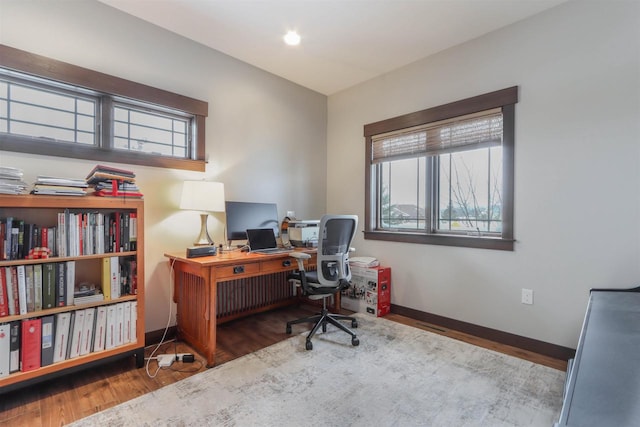 home office with hardwood / wood-style floors and radiator