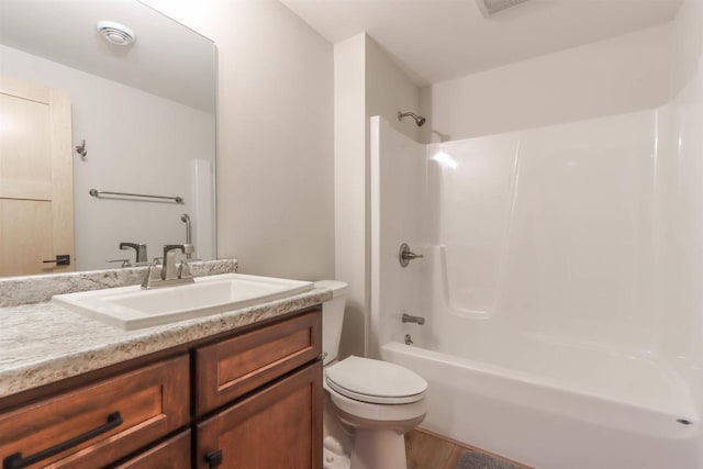 full bathroom with bathtub / shower combination, vanity, and toilet