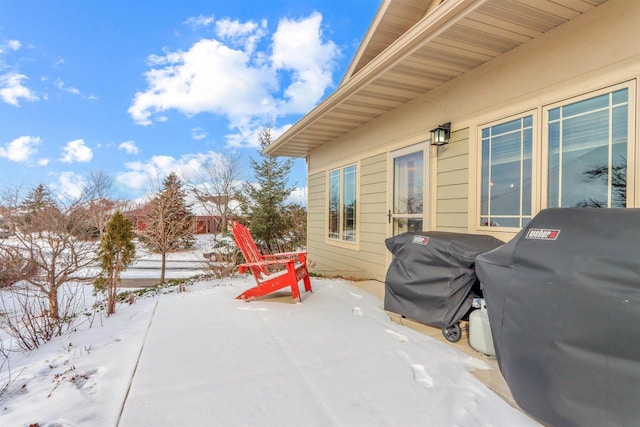 snow covered patio featuring grilling area