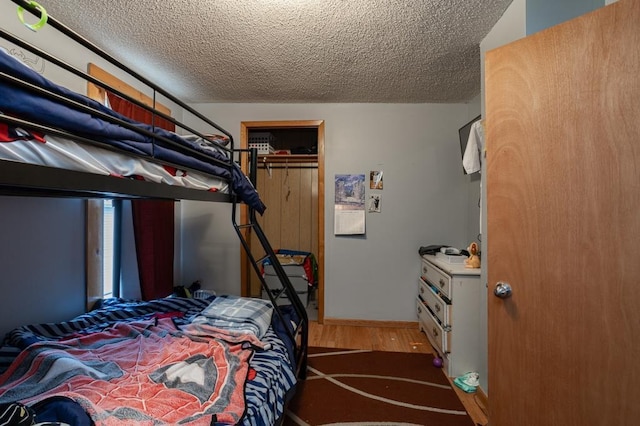 500 E 5th St, Merrill, WI 54452 - bedroom featuring hardwood / wood-style floors, a textured ceiling, and a closet