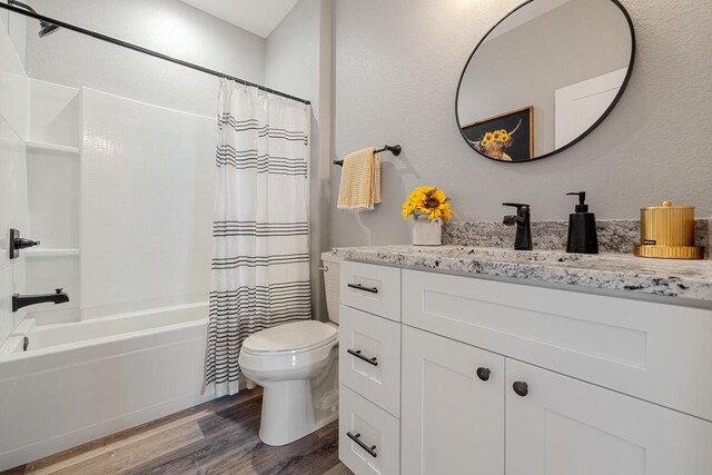 full bathroom featuring toilet, shower / tub combo, wood finished floors, and vanity