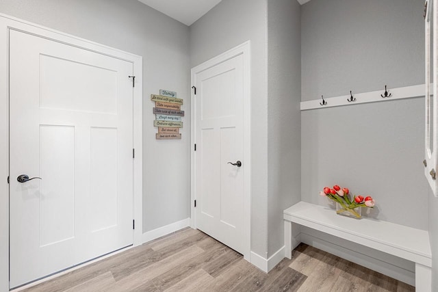 mudroom with light wood-style floors and baseboards