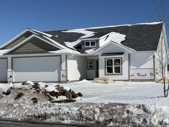 view of front of house featuring a garage and a shingled roof