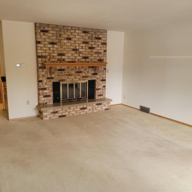 unfurnished living room with a fireplace and carpet floors